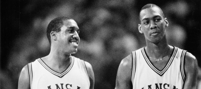 Kansas University basketball teammates Calvin Thompson (#35) and Danny Manning (#25) congratulate each other in this 1985 file photo. Thompson and Manning were part of a 1985-1986 squad that earned the program's 1,300th victory by defeating SIU-Edwardsville in December.