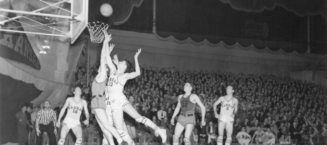 Kansas University basketball players contend with a Missouri player for a rebound in this 1939 file photo. The Jayhawks defeated the Tigers in January 1939 to snare the program's 500th victory. The game, which KU won, 37-32, was played at Hoch Auditorium in Lawrence.