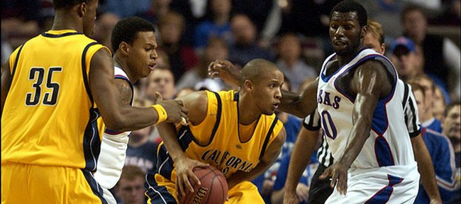 Omar Wilkes began his college career as a KU guard then transferred to Cal after playing sparingly during the 2003-04 season. Wilkes, who has filmed some commercials, worked as an assistant to the production team on the Will Smith movie, Hancock. In this December 11, 2005, file photo, he looks for help while pressured by Brandon Rush, second from left, and Julian Wright, as Cal's DeVon Hardin (35) looks to lend a hand.