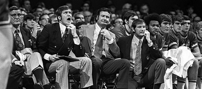 1970's:   Ted Owens, (on knee at right) head basketball coach at the University of Kansas, with assistants Bob Frederick and Sam Miranda in Lawrence, KS.