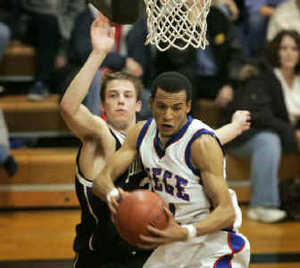 Bishop Mieges Travis Releford (right), an All-Metro pick, said Tuesday that he will play college basketball at Kansas. 
